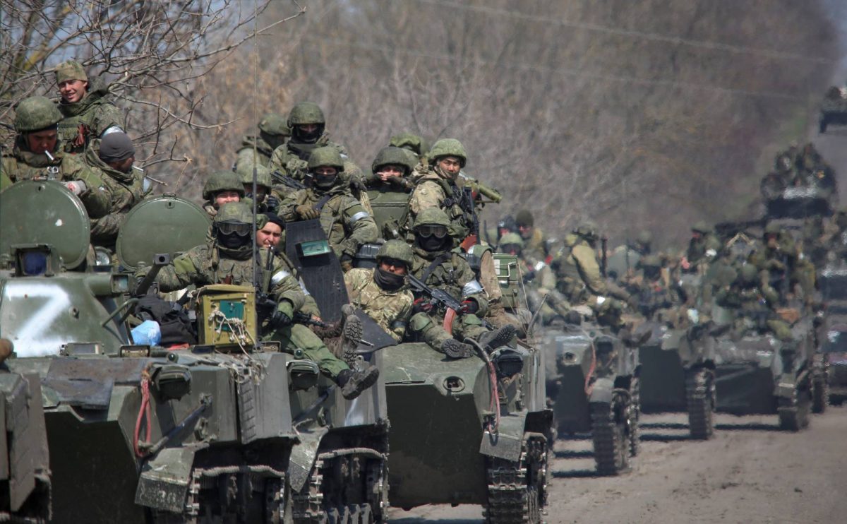 Service members of pro-Russian troops ride on armoured vehicles in the course of Ukraine-Russia conflict on a road leading to the city of Mariupol, Ukraine April 15, 2022.  REUTERS/Chingis Kondarov NO RESALES. NO ARCHIVES