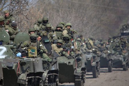Service members of pro-Russian troops ride on armoured vehicles in the course of Ukraine-Russia conflict on a road leading to the city of Mariupol, Ukraine April 15, 2022.  REUTERS/Chingis Kondarov NO RESALES. NO ARCHIVES