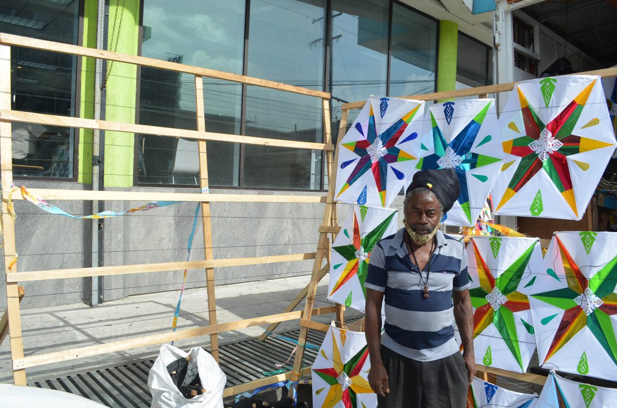 Maurice Prince standing in front of his beautifully decorated kites 