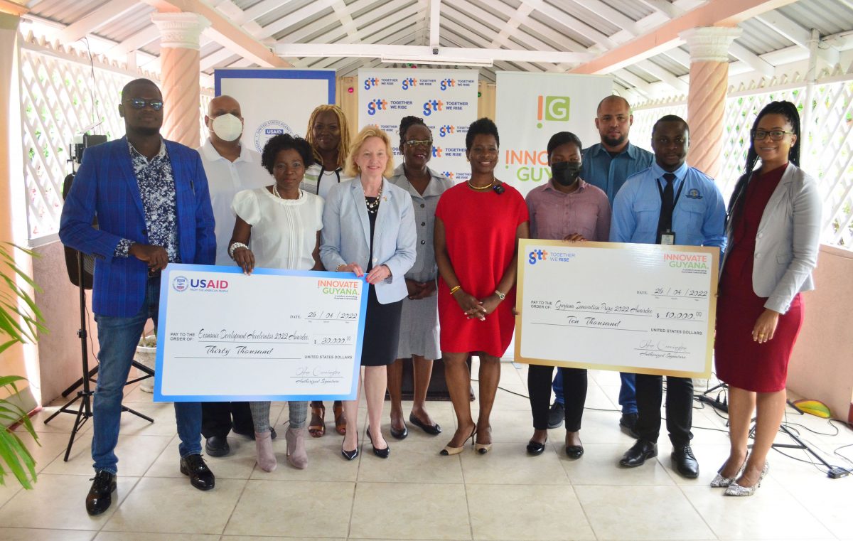US Ambassador to Guyana Sarah-Ann Lynch (third, from left in front row), CEO of Guyana Economic Development Trust, Oslene Carrington, (at centre), GTT Senior Manager of Business Solutions Unit, Tanya Wilcott (at right) along with the awardees. 