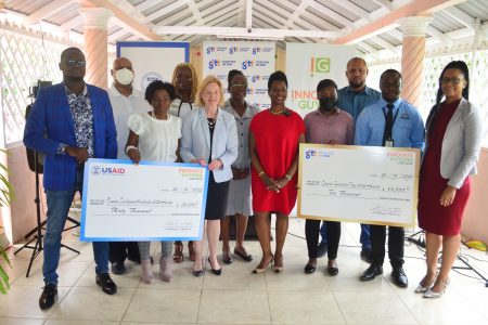 US Ambassador to Guyana Sarah-Ann Lynch (third, from left in front row), CEO of Guyana Economic Development Trust, Oslene Carrington, (at centre), GTT Senior Manager of Business Solutions Unit, Tanya Wilcott (at right) along with the awardees. 