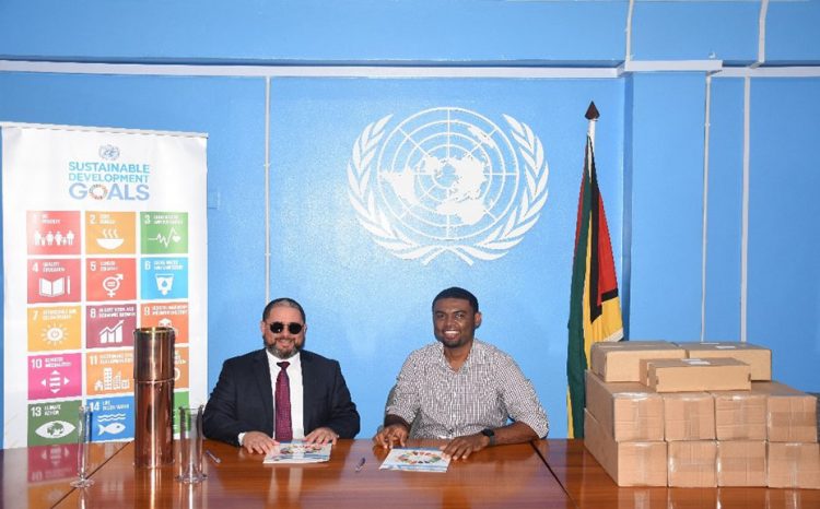 Dr. Garvin Cummings, Chief Hydrometeorological Officer, Ministry of Agriculture (right) and Jairo Valverde Bermudez, Resident Representative of United Nations Development Pro-gramme at the signing. 