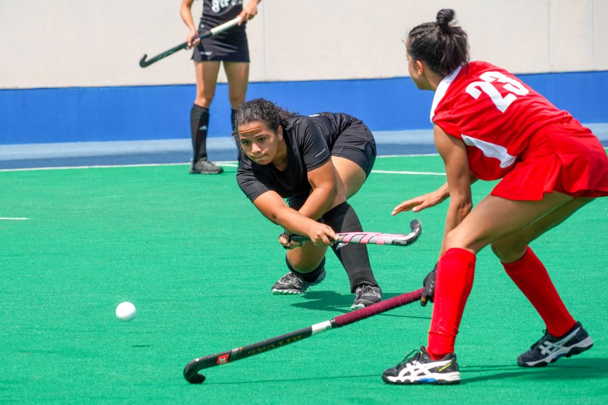 Guyana’s Kirsten Gomes (black) attempting a pass while being marked by Isamarie Ramos of Puerto Rico during the opening fixture of the CAC Games Hockey Qualifier