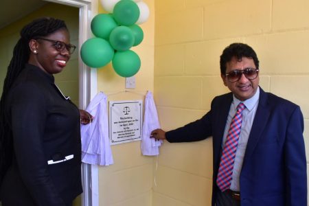 Magistrate Wanda Fortune (left) and Attorney General Anil Nandlall SC unveiled the commemorative plaque at yesterday’s commissioning of the new Kwakwani Magistrate’s Court building.  (DPI photo)