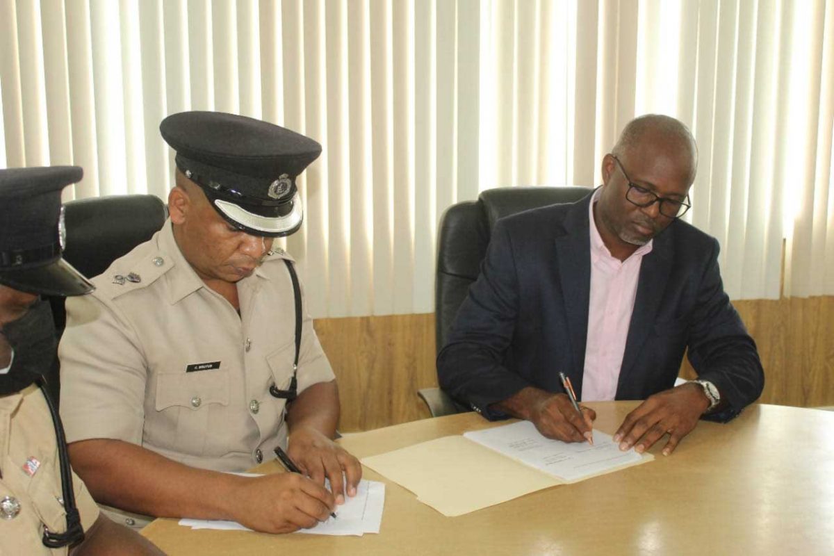 Deputy Commissioner of Police ‘Administration’, Calvin Brutus (left) and GCCI Junior Vice President, Kester Hutson signing the MoA yesterday. (Police photo)
