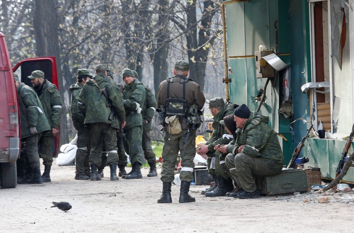 Service members of pro-Russian troops gather in a street during Ukraine-Russia conflict in the southern port city of Mariupol, Ukraine April 17, 2022. REUTERS/Alexander Ermochenko