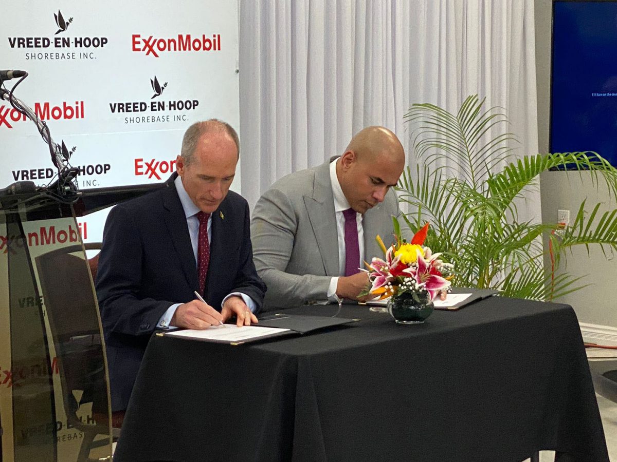 ExxonMobil Guyana President Alistair Routledge (lrft) and NRG Holding Inc Secretary Andron Alphonso signing the lease agreement 