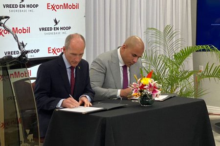ExxonMobil Guyana President Alistair Routledge (lrft) and NRG Holding Inc Secretary Andron Alphonso signing the lease agreement 