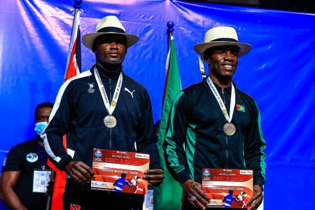 American Boxing Confederation (AMBC) Elite Championships bronze medalist, Desmond Amsterdam (right) posing with cheque in Ecuador with a fellow podium dweller.