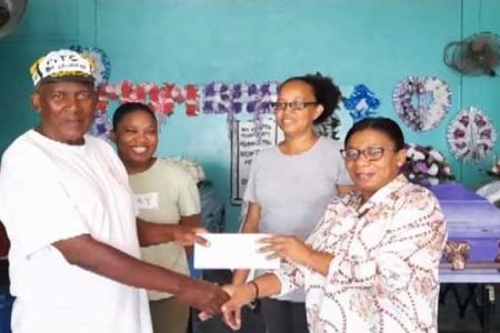 Proprietor of Arokium Funeral Home, Pearl Arokium hands over the sponsorship cheaque to Flying Ace’s Randolph Roberts