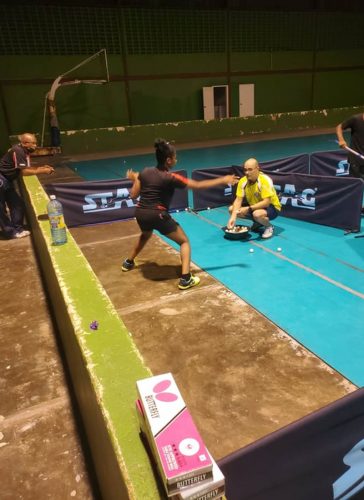 Cuban table tennis coach Osdani Romero Garcia carries junior player Jasmine Billingy through her paces while national coach Linden Johnson pays keen attention to how Billingy is executing the drill. (Photo by Donald Duff)