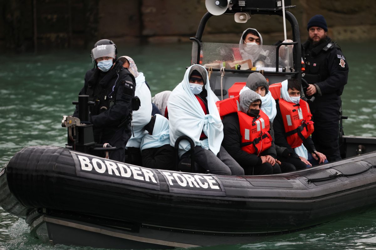 FILE PHOTO: Migrants arrive into the Port of Dover onboard a Border Force vessel after being rescued while crossing the English Channel, in Dover, Britain, December 17, 2021. REUTERS/Henry Nicholls