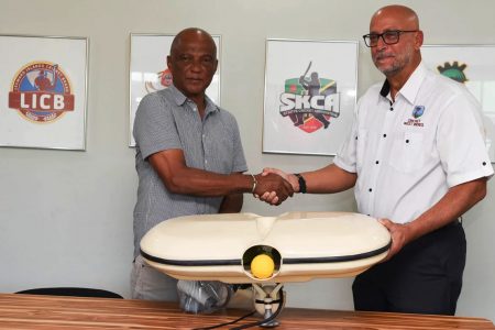 CWI President, Ricky Skerritt, right, makes the presentation to President of the St Kitts Cricket Association, Dennis Phillip.