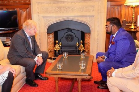 President Irfaan Ali (right) meeting yesterday with British Prime Minister Boris Johnson. A statement by the Office of the President said that Ali held discussions with the Prime Minister on matters relating to Guyana’s agriculture agenda, the country’s energy potential and Prime Minister Johnson’s Coalition of Forest Alliance Initiative.  The President was in the UK for a series of engagements. (Office of the President photo)