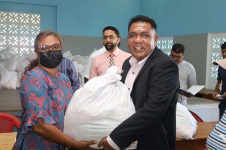 Agriculture Minister Zulfikar Mustapha hands over a hamper to the wife of a fisherman 