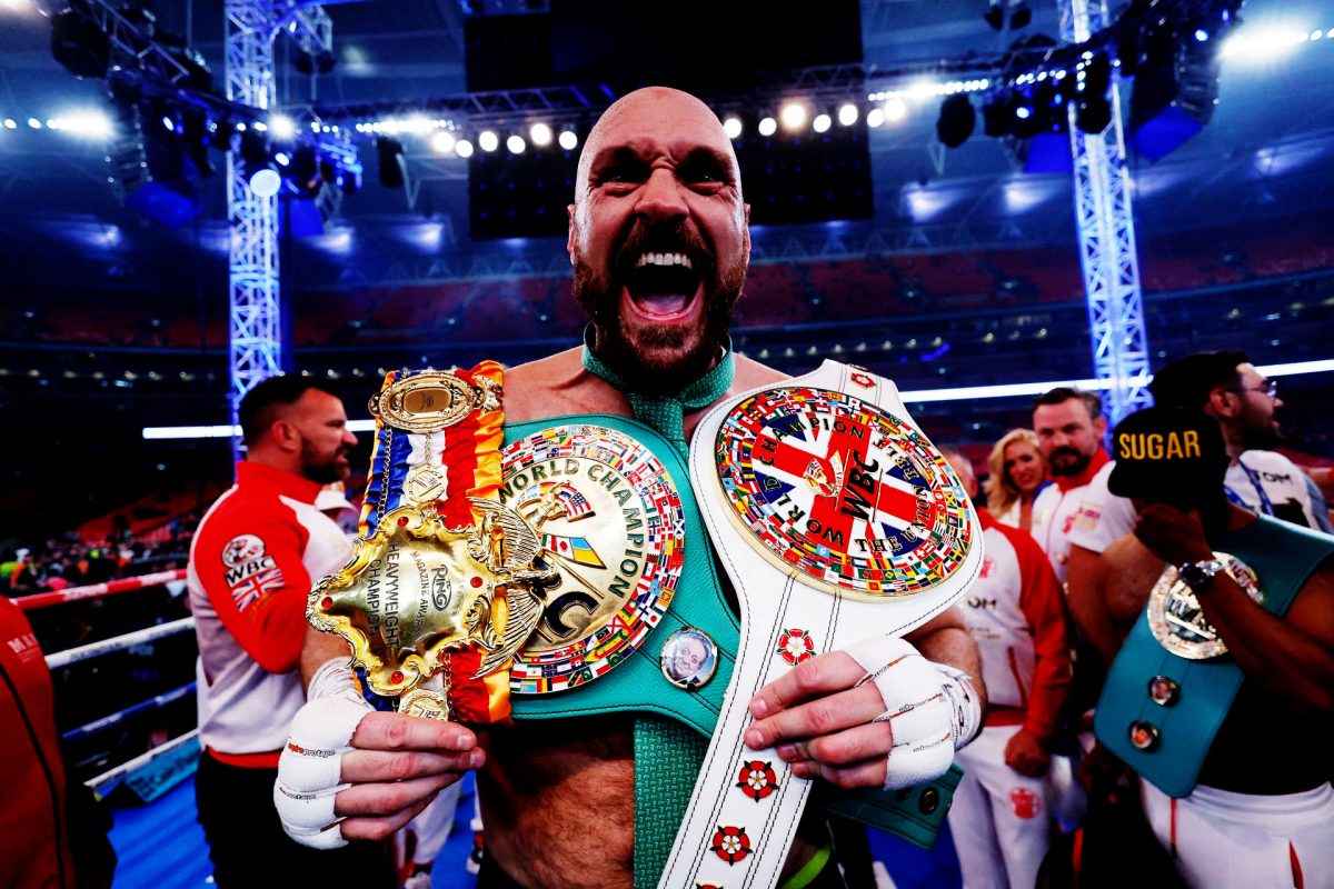 Tyson Fury celebrates with the belts after winning his fight against Dillian Whyte. Reuters/Andrew Couldridge