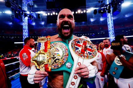 Tyson Fury celebrates with the belts after winning his fight against Dillian Whyte. Reuters/Andrew Couldridge