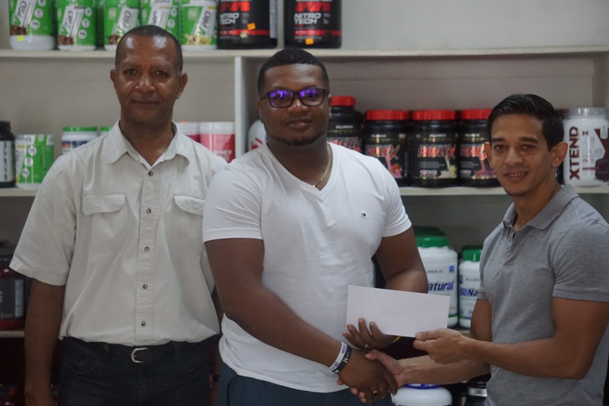 Organiser of the Arrowhead League, Treiston Joseph (middle) collects sponsorship from
proprietor of Fitness Express, Jamie McDonald (right), while president of the AAG, Aubrey Hutson, looks on