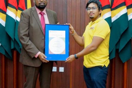 President  Irfaan Ali yesterday presented the Outstanding Cambridge Learners Award to School of the Nations’ sixth-form student John McGrath.
The Guyanese teen was awarded the prize and title of the World’s Top Student for Cambridge International Advanced Subsidiary (AS) English Language after he was able to secure 99 marks out of 100 in the June 2021 Examinations, a release from the Office of the President said.
His result was reported to be better than over one million students from across 136 countries.
The ceremony took place at the Office of the President on Shiv Chanderpaul Drive. (Office of the President photo)