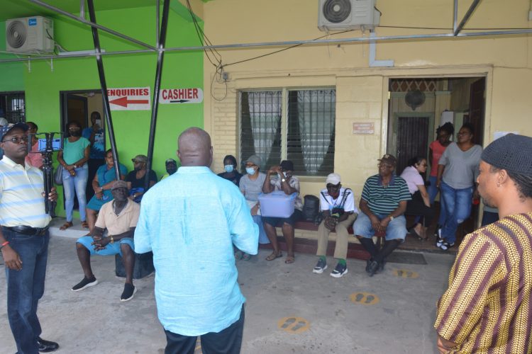 Leader of the PNCR Aubrey Norton (centre) speaking with members of the Linden Utility Services Cooperative Society Limited.  (PNCR photo)