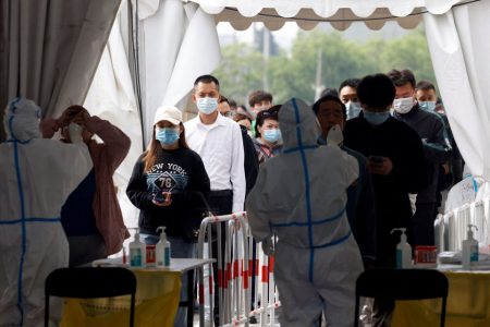 Medical workers in protective suits collect swabs from residents at a makeshift nucleic acid testing site amid the coronavirus disease (COVID-19) outbreak in Beijing, China April 29, 2022. REUTERS/Carlos Garcia Rawlins