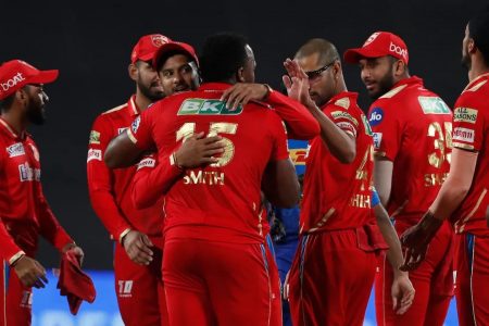  Oden Smith is congratulated by Shikhar Dhgawan and the rest of the Punjab Kings players after bagging three wickets in the final over to help PBKS hand Mumbai Indians their fifth defeat in as many matches. (Photo courtesy IPL website)