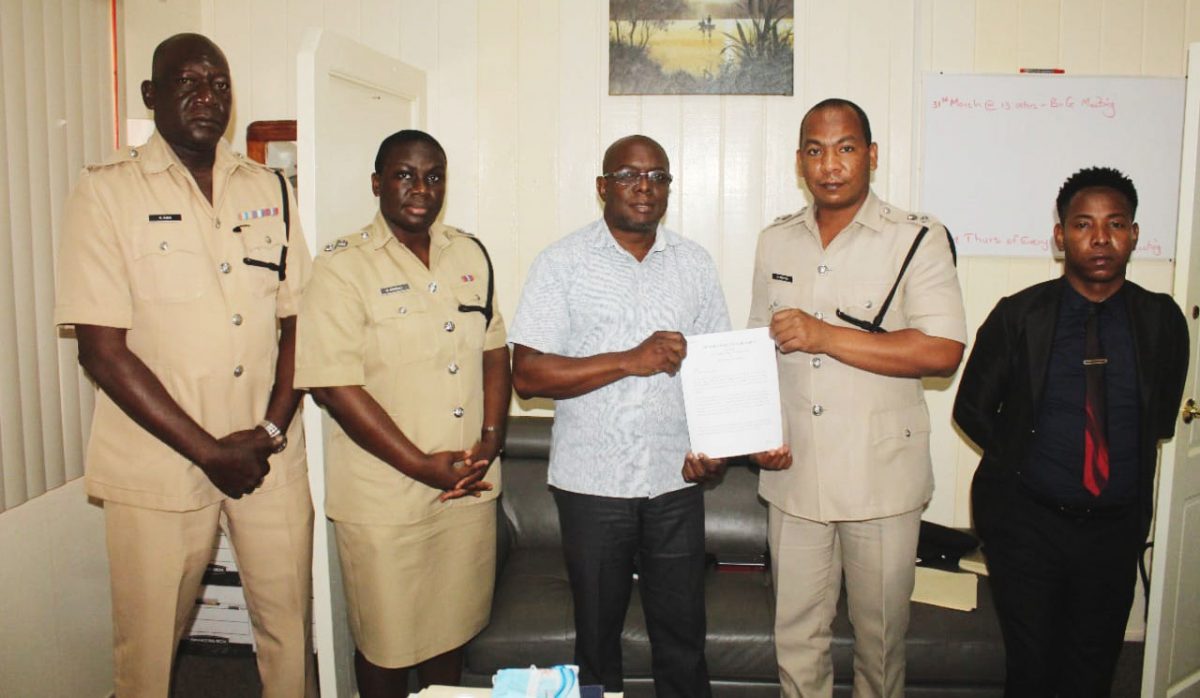 Deputy Commissioner ‘Administration’, Calvin Brutus (second from right) and GITC’s Administrator, Dexter Cornette (third from left) pose with the Memorandum of Agreement. Also in the photo are Force Training Officer, Keithon King (left); Head of the Strategic Planning Unit, Woman Assistant Superintendent of Police, Nicola Kendall (second from left) and Police Legal Advisor, Mandel Moore (right). (Police photo)
