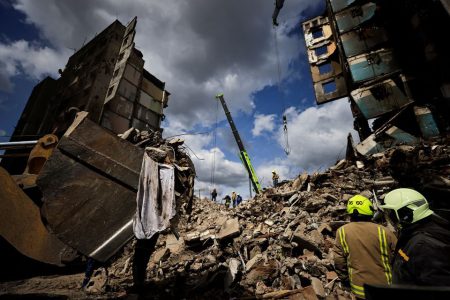 Rescuers search for bodies under the rubble of a building destroyed by Russian shelling, amid Russia's Invasion of Ukraine, in Borodyanka, Kyiv region, Ukraine April 11, 2022. REUTERS/Zohra Bensemra