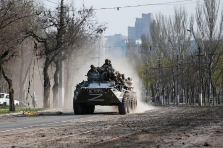 Service members of pro-Russian troops ride an armored personnel carrier during the Ukraine-Russia conflict in the southern port city of Mariupol, Ukraine on Friday, April 15, 2022. Russia says its troops cleared Mariupol and only a small contingent of Ukrainian fighters remain inside a steelworks. (REUTERS/Alexander Ermochenko photo) 