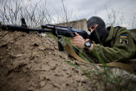 A Ukrainian serviceman points a rifle at his position during tactical exercises at a military camp, amid Russia's invasion of Ukraine, in Zaporizhzhia region, Ukraine, April 29, 2022. (photo credit: REUTERS/UESLEI MARCELINO)