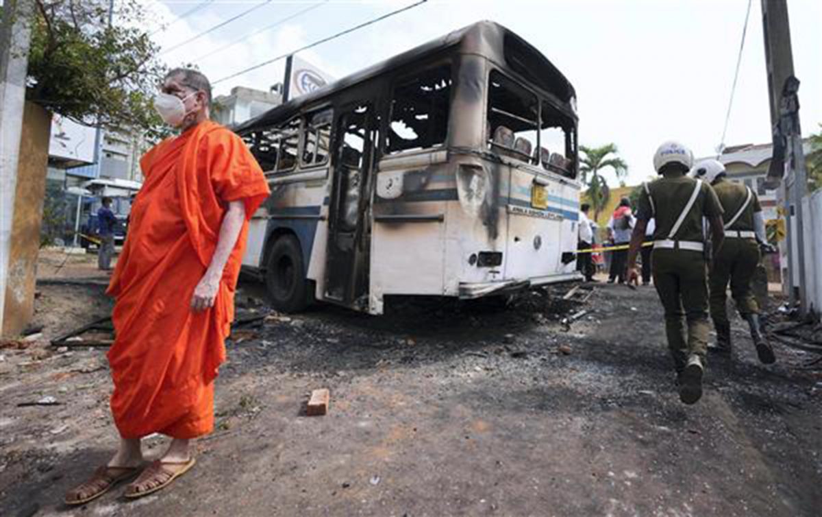A Sri Lankan Buddhist monk, supporter of president Gotabaya Rajapaksa, inspects debris created by overnight clashes between protesters and police near the Sri Lankan Presidents private residence on the outskirts of Colombo, Sri Lanka, Friday, April 1, 2022. AP/PTI