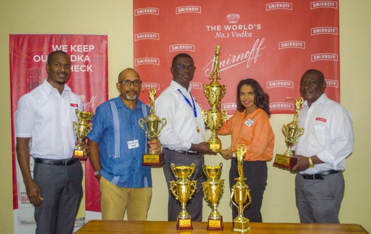 Gavin Todd presents the first place trophy to Anasha Ally while Chet Bowling, Ian Charles and Troy Peters display some of the other trophies up for grabs