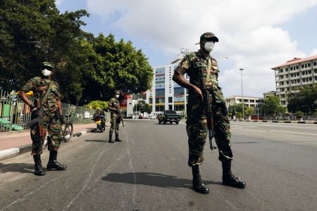 Sri Lankan army soldiers stand guard at a checkpoint after the government imposed a curfew following a clash between police and protestors near Sri Lankan President Gotabaya Rajapaksa's residence during a protest last Thursday, amid the country's economic crisis, in Colombo, Sri Lanka April 3, 2022. REUTERS/Dinuka Liyanawatte