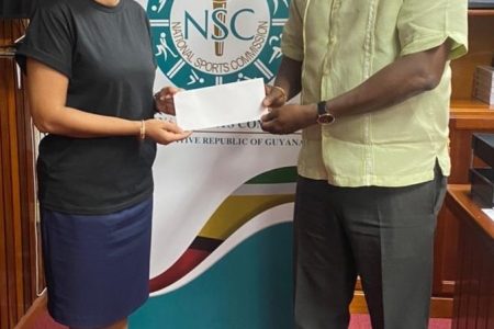Director of Sport, Steve Ninvalle (right), presenting the NSC’s $1.6M cheque to GBA Secretary, Emily Ramdhani.
