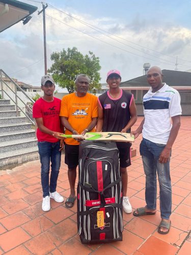 Ruhan Swar (second from right) presents the cricket gear to Transport’s Shaun Massiah (extreme right) in the presence of his manager, Wesley King and Dave Mohabir of Transport (extreme left)