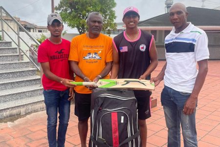 Ruhan Swar (second from right) presents the cricket gear to Transport’s Shaun Massiah (extreme right) in the presence of his manager, Wesley King and Dave Mohabir of Transport (extreme left)
