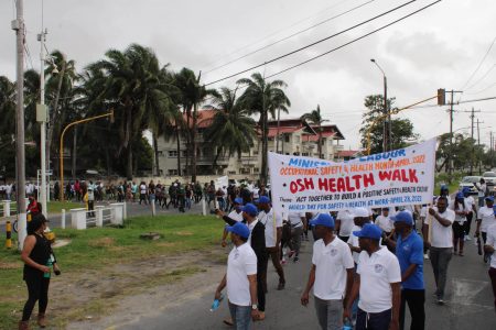 The Occupational Safety and Health Department of the Ministry of Labour’s Annual Health Walk saw more than five  hundred persons, representing the Labour Ministry, Guyana Power and Light (GPL), Exxon Guyana, Georgetown Public Hospital Corporation, the National Insurance Scheme (NIS), the Centre for Local Business Development, Professional Guard Services, Bounty Farm Limited, N&S Algoo Inc, License Customs Brokers, Teleperformance, University of Guyana, Ministry of Foreign Affairs and International Corporation, Ministry of Health, Guyana Geology and Mines Commission, Guyana Water Incorporated (GWI), GTT, Eureka Laboratory and the Ministry of Public Infrastructure, among other agencies.
The walk was held yesterday morning in observance of OSH Month, raising awareness for safety and Health in the workplace, throughout Guyana.
The walk concluded at the Square of the Revolution, where the gathering was engaged by Minister Joseph Hamilton who thanked them for their participation. A segment of the march (Ministry of Labour photo)