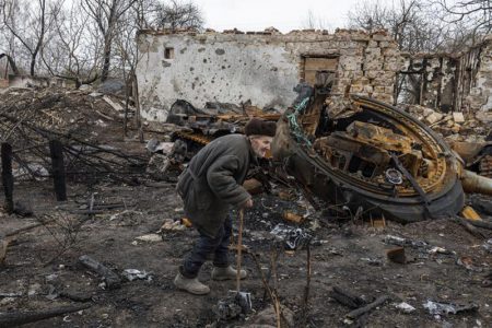 Oleksii Shcherbo, 98, walks past his burnt out house and destroyed Russian tank in the village of Sloboda, outside Chernihiv, Ukraine, April 5. REUTERS/Marko Djurica