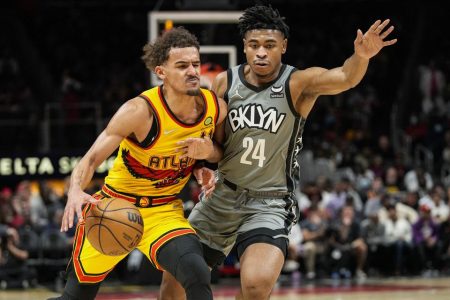 Atlanta’s Trey Young (with ball) scored nine points in the final minute to help the Hawks outlast the Brooklyn Nets Saturday night.