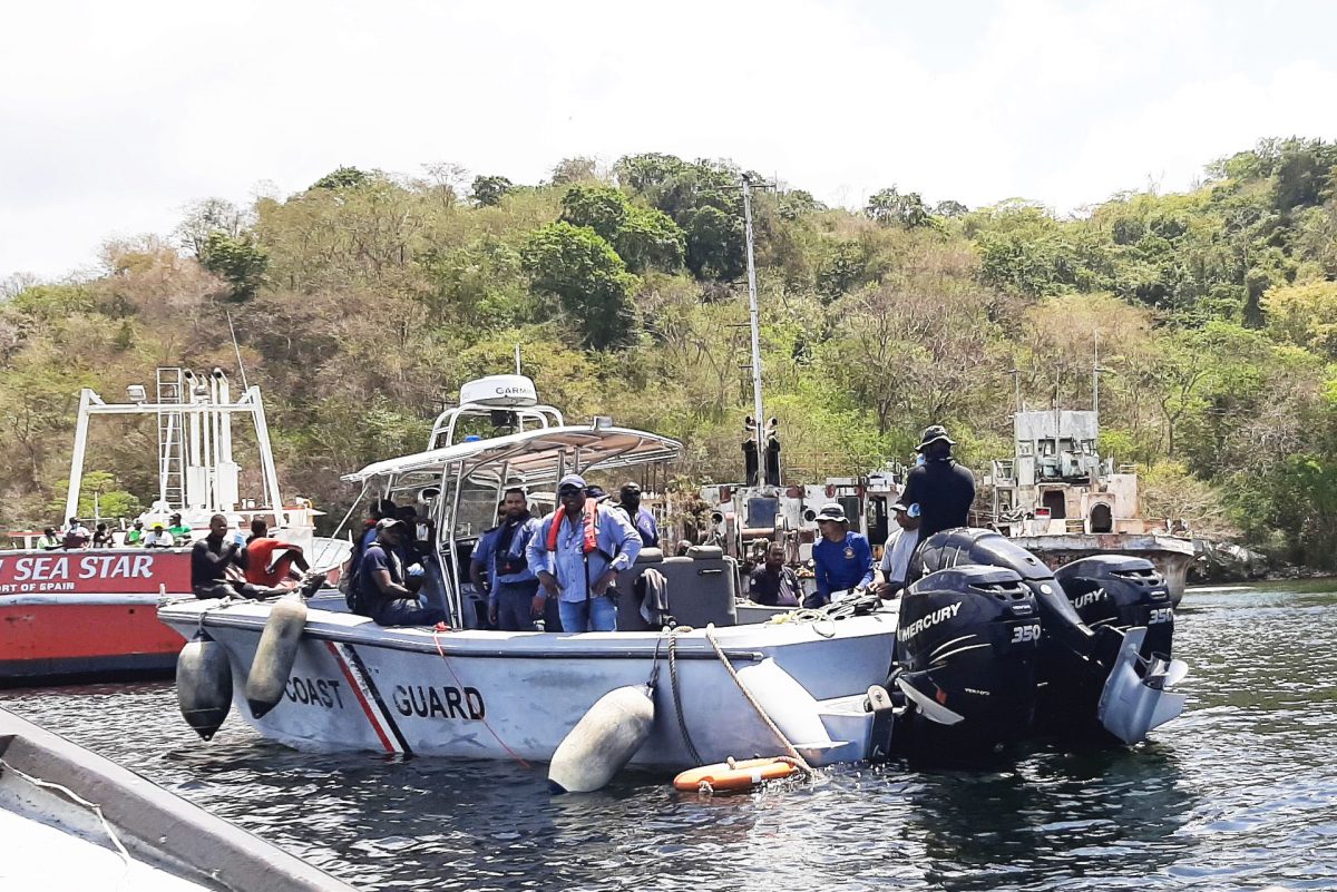 Coast Guard officers during an attempt to retrieve the bodies of four missing crewmen in the sunken vessel, the MV Fair Chance, just off Chaguaramas on April 9.