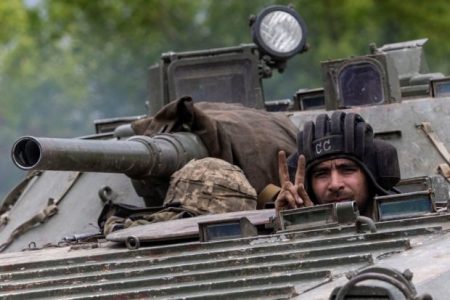 A Ukrainian service member rides on top of a military vehicle, amid Russia’s invasion of Ukraine, on the road from Bakhmut to Kostyantynivka, in the Donetsk region, Ukraine, May 29, 2022 (REUTERS)