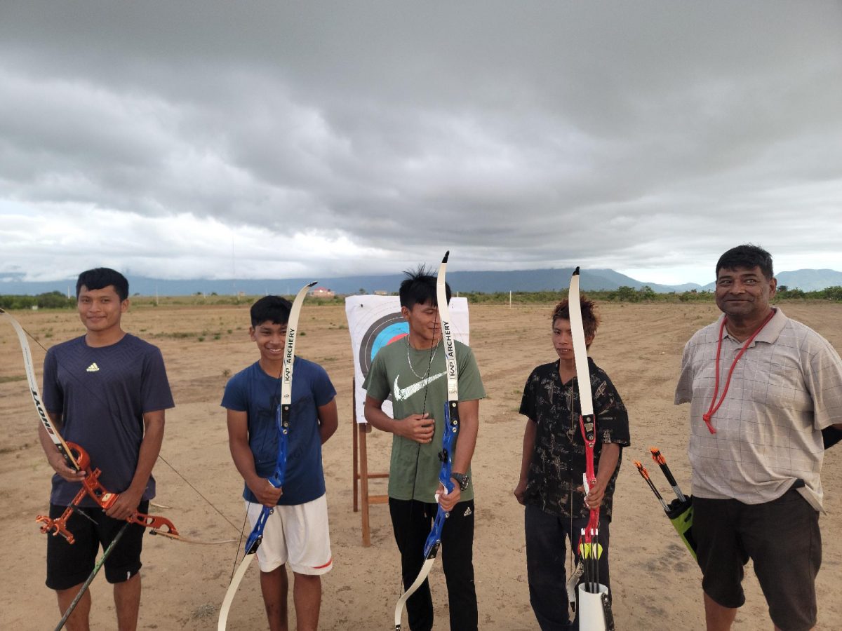 Some of the participants posing for a photo opportunity alongside senior coach of Archery Guyana Robert Singh (left) following the conclusion of the training seminar