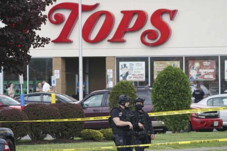 Police secure an area around a supermarket where at least 10 people were killed in a shooting. Photograph: Derek Gee/AP