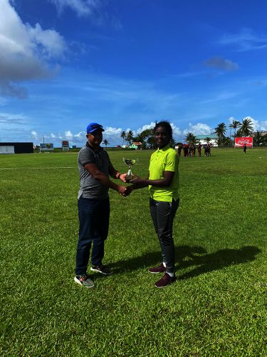 Naomi Barkoye receives her player of the match award from Balram Samaroo