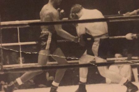 Former lightweight boxer, Al Brown (left) in combat during one of his 59 professional bouts. Brown whose career spawned from 1948-1957, passed away on Tuesday at the age of 91 in England.