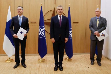Finland’s Ambassador to NATO Klaus Korhonen (left), NATO Secretary-General Jens Stoltenberg (centre) and Sweden’s Ambassador to NATO Axel Wernhoff attend a ceremony to mark Sweden’s and Finland’s application for membership in Brussels, Belgium on May 18, 2022. (Johanna Geron / Pool via Reuters)