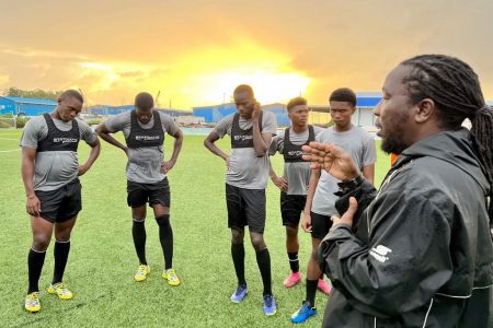 Assistant-coach Wayne ‘Wiggy’ Dover (right), making a point to a cadre of players at the National Training Centre, Providence