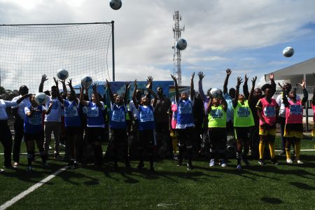 Players and officials of the Blue Water Shipping Girls Under-15 Developmental League celebrate the official launch of the tournament 