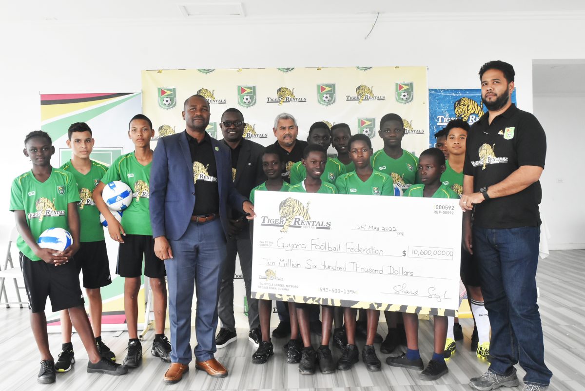 GFF President Wayne Forde (4th from left) posing with several players and officials from Tiger Rentals following the official announcement of the National U-13 Developmental League