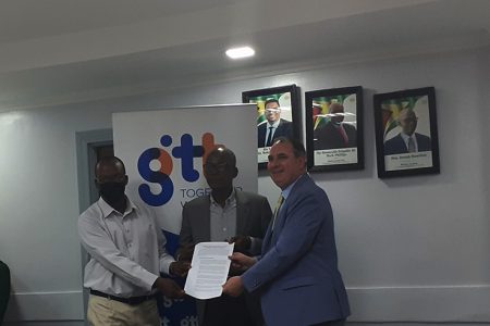 From left are GPTWU President Harold Shepherd, Minister of Labour Joseph Hamilton and CEO of GTT Damian Blackburn with the newly signed MoU 